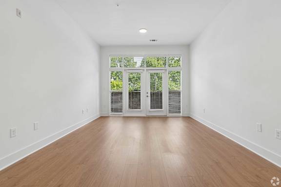 A room with wooden floors and white walls.