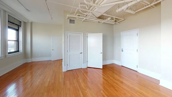 A room with wooden floors and white walls.