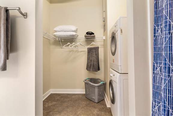 A small laundry room with a washer and dryer.