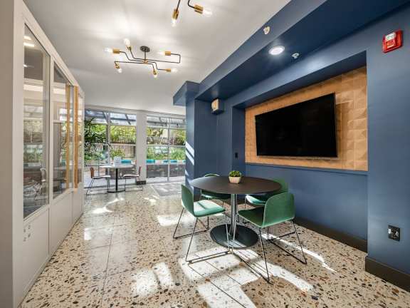 A blue room with a table and chairs.