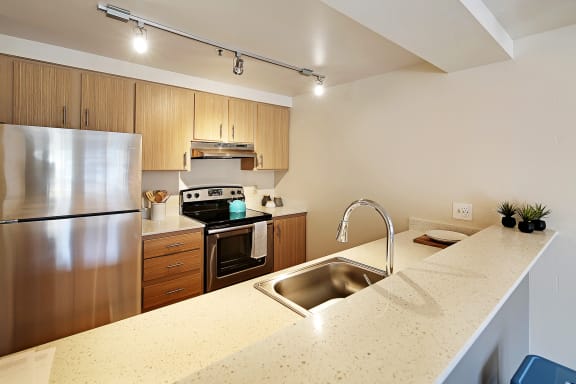 a kitchen with stainless steel appliances and a granite counter top  at Townside Flats, Redmond, 98052