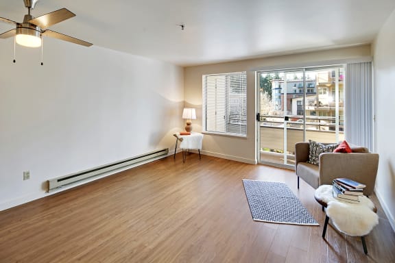 a living room with a couch and a chair and a window  at Townside Flats, Redmond, 98052