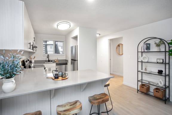 an open kitchen with a white counter top and a large island with two stools at Brix, Walla Walla, WA, 99362