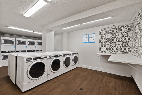 a washer and dryer in a laundry room with white appliances and a counter