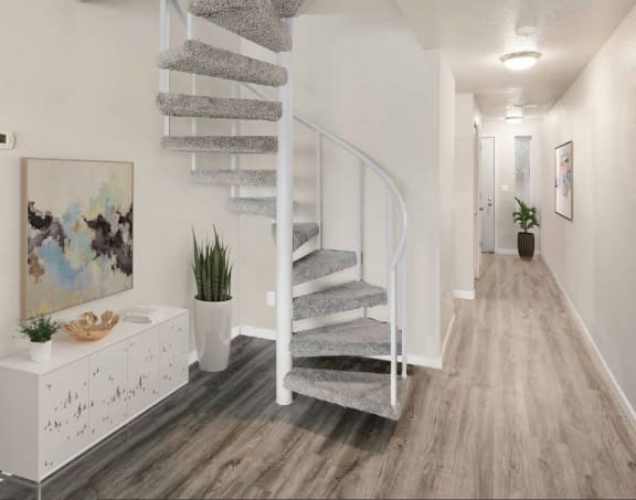 Carpeted spiral staircase with white railings leading to the loft.at Capitol Crossing, Olympia, Washington