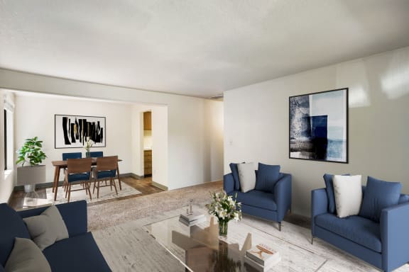 a living room with blue couches and chairs and a dining room table at Cedarwood, Washington, 98801