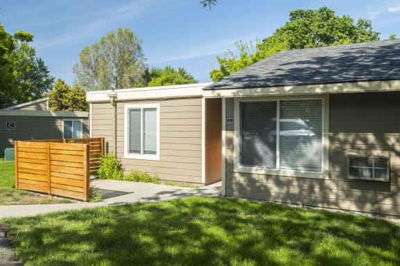 a small house with a yard and a wooden fence at Park View Apartments, Washington, 98801
