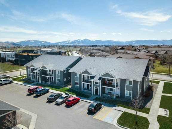 an aerial view of a building with cars parked in a parking lot at Madison Park, Bozeman