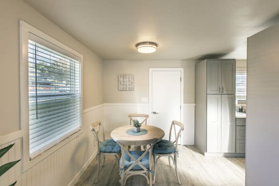 a small dining room with a table and chairs at The Lakes Apartments, Moses Lake Washington