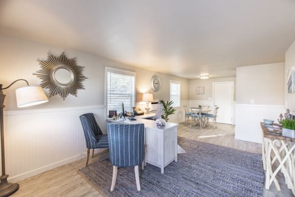 a living room and dining room with a table and chairs at The Lakes Apartments, Moses Lake, WA 98837