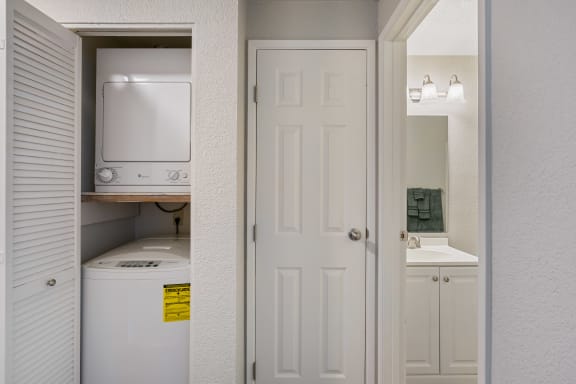 a white kitchen with a white door and a white refrigerator and sink at Capitol Crossing, Olympia, WA