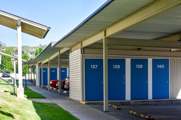 a row of blue and white portable toilets in front of a building