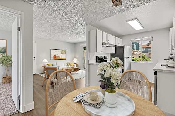 A dining room with a table set for two at our apartments for rent in Fife, WA..