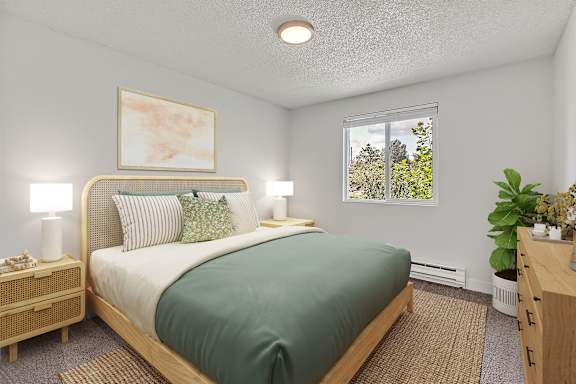 A bedroom with a bed, nightstand, and window at The Landing Apartments in Fife, WA..