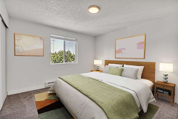 A bedroom with a large bed and two lamps at the Landing Apartments Fife, WA.