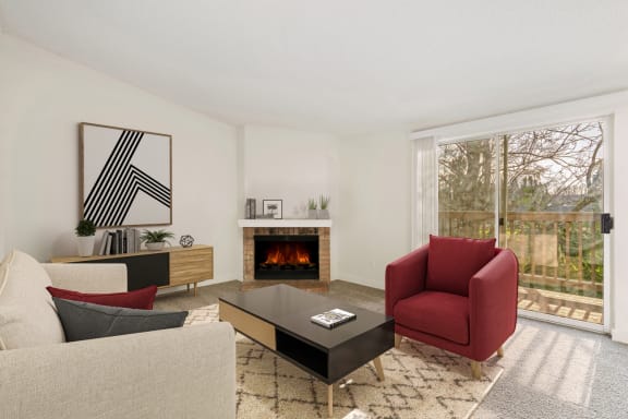 a living room with couches and a coffee table and a fireplace