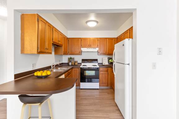 a kitchen with white appliances and wooden cabinets at Rock Creek, Billings Montana