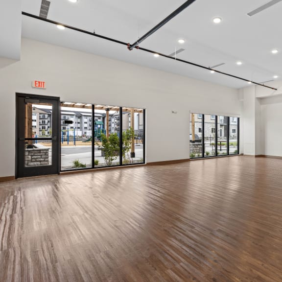 an empty living room with a wood floor and a door to a building at Yellowstone Landing, Montana, 59714
