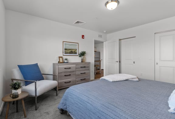 a bedroom with a bed and a dresser and a chair at Yellowstone Landing, Montana