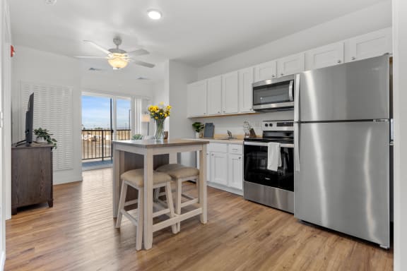 a kitchen with stainless steel appliances and a island with a stool at Yellowstone Landing, Montana, 59714