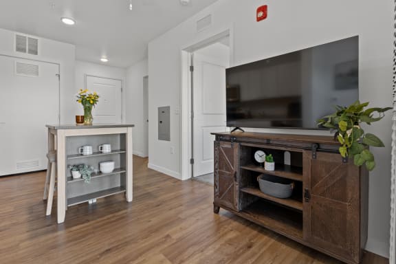 a living room with a tv and a wooden entertainment center at Yellowstone Landing, Belgrade, MT, 59714