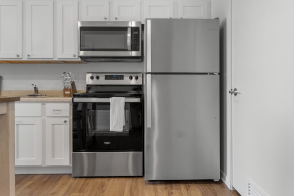 a kitchen with stainless steel appliances and a refrigerator at Yellowstone Landing, Montana