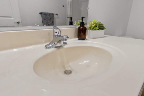 a sink in a bathroom with a mirror and a plant at Yellowstone Landing, Belgrade, MT