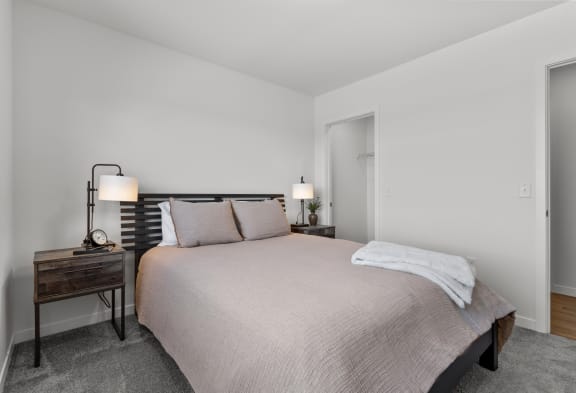 a bedroom with a bed and a nightstand with two lamps at Yellowstone Landing, Belgrade, MT