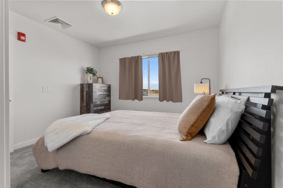 two pillows on a bed in a bedroom with a window at Yellowstone Landing, Belgrade, 59714