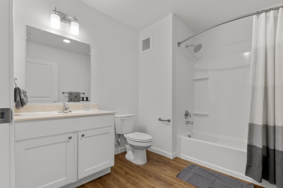 a white bathroom with a shower toilet and sink  at Yellowstone Landing, Montana