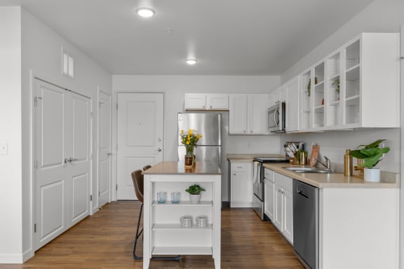 a kitchen with white cabinets and stainless steel appliances  at Yellowstone Landing, Montana, 59714
