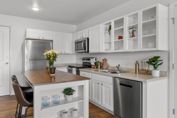 a kitchen with white cabinets and stainless steel appliances and a counter top  at Yellowstone Landing, Montana, 59714