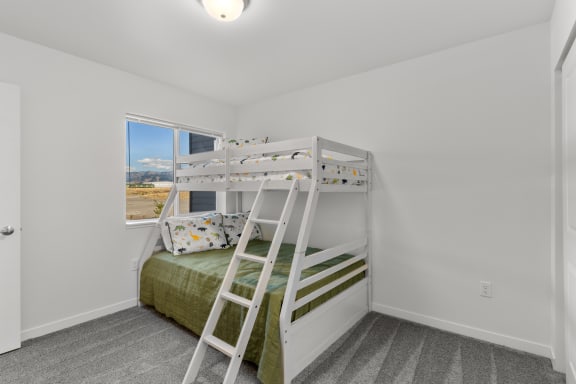 two bunk beds in a room with a window at Yellowstone Landing, Belgrade, MT