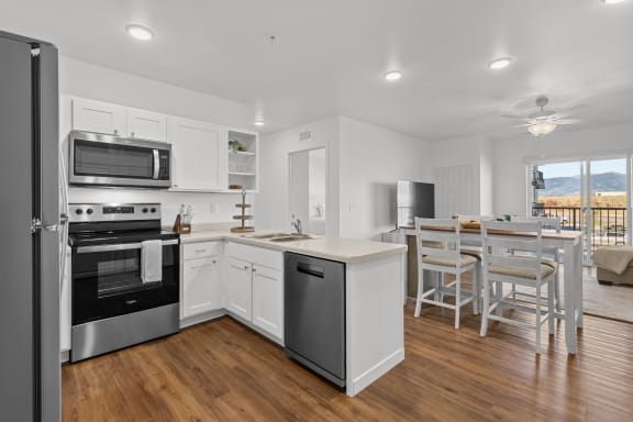 an open kitchen and dining room with a table and chairs  at Yellowstone Landing, Belgrade, 59714
