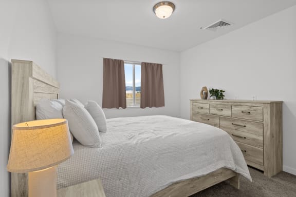 a bedroom with a bed and a dresser and a window at Yellowstone Landing, Montana, 59714