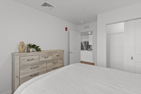 a bedroom with a bed and a dresser and a bathroom at Yellowstone Landing, Montana