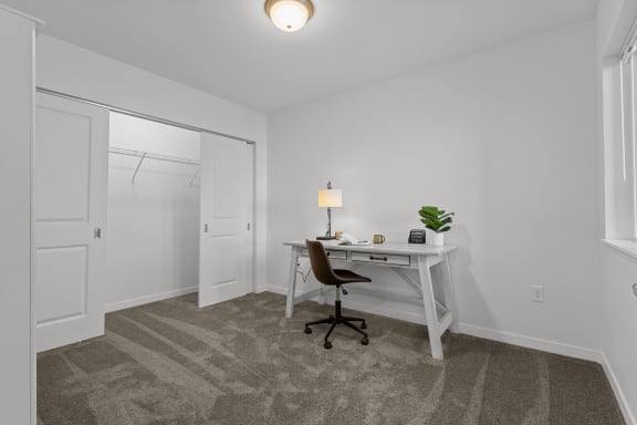 a bedroom with a desk with a chair and a closet at Yellowstone Landing, Belgrade, Montana