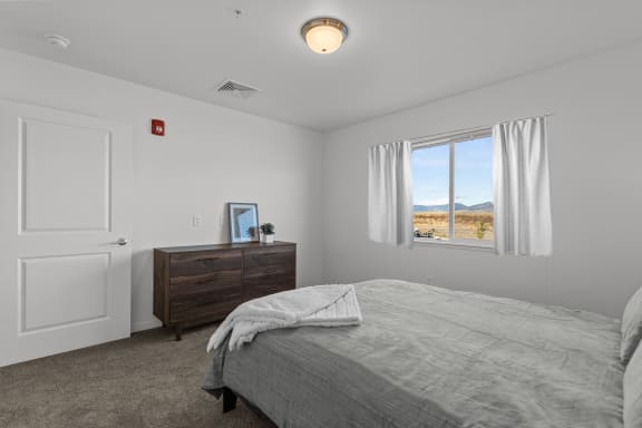 a bedroom with a bed and a window at Yellowstone Landing, Belgrade, Montana