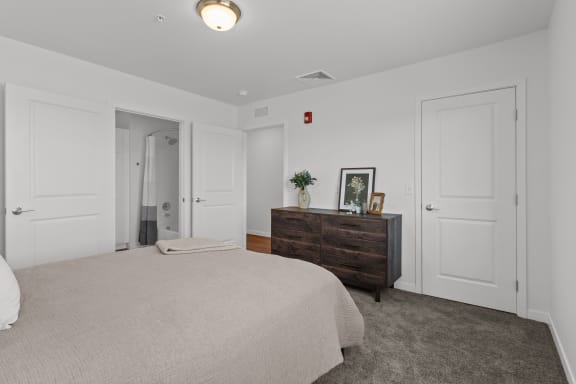 a bedroom with white walls and white furniture and white doors at Yellowstone Landing, Belgrade, Montana