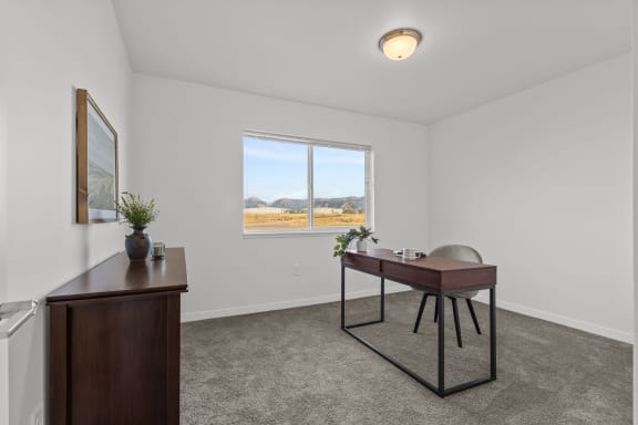 a living room with a desk and a window  at Yellowstone Landing, Montana, 59714