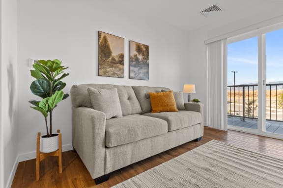 a living room with a couch and a door to a balcony at Yellowstone Landing, Belgrade, MT, 59714