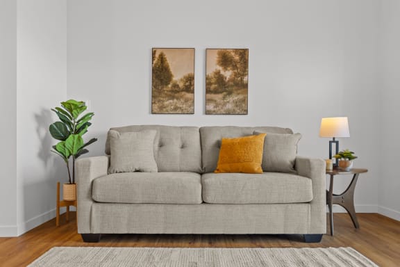 a living room with a couch and two paintings on the wall at Yellowstone Landing, Montana