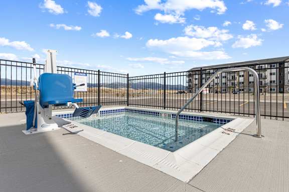 A blue chair sits next to a small pool.at Yellowstone Landing, Montana
