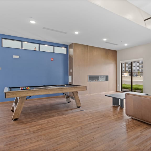 a game room with a pool table and a blue wall at Yellowstone Landing, Montana