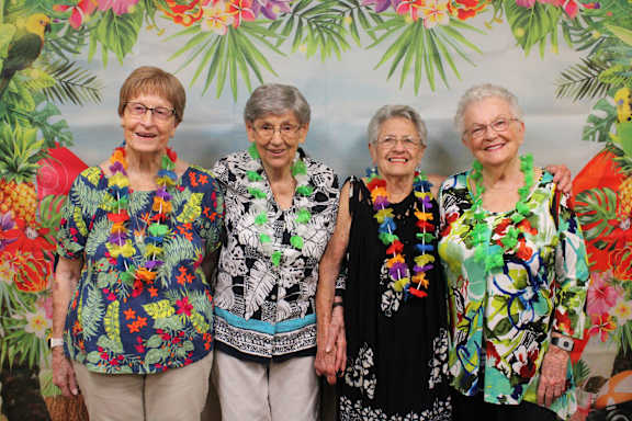 a group of women standing together in front of a tree at Campus Commons Senior Living, Sacramento, 95825
