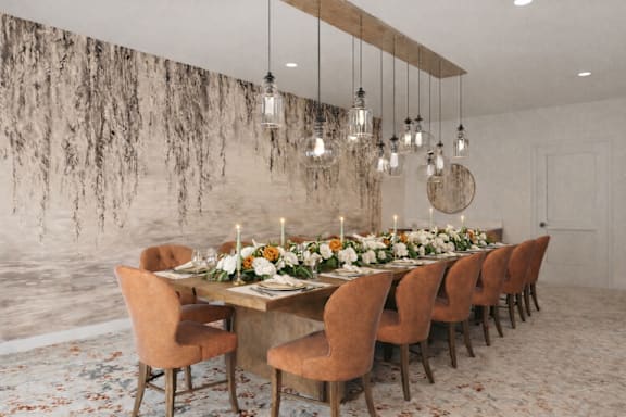 A long table is set with candles and flowers for a formal dinner.