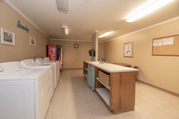 A laundry room with washers and dryers.