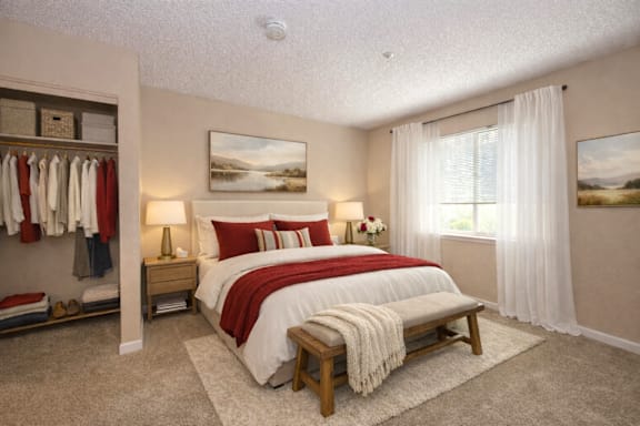A bedroom with a large bed and a painting on the wall.