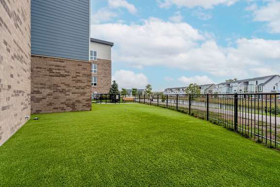 A green lawn in front of a building.