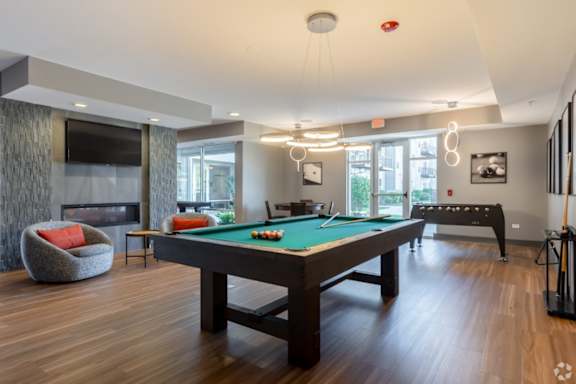 Game room with pool table and foosball at Arden of Oak Brook Apartments, Oakbrook Terrace, Illinois